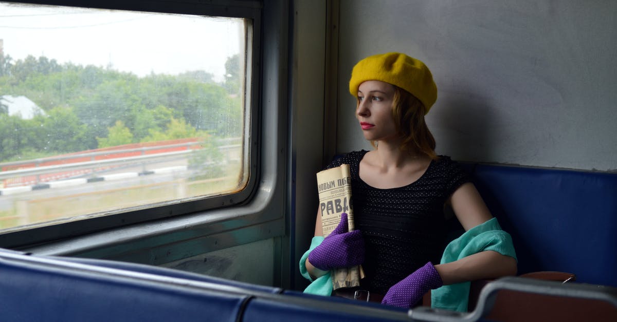 Where exactly in Italy to where in Russia is the train going? - Pensive woman with newspaper in train