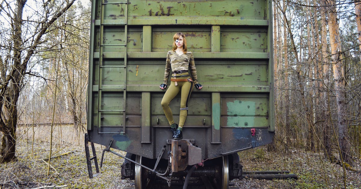 Where is agent Murphy in season 3? - Slim woman wearing modern camouflage outfit with eye patch standing on aged green train in woods
