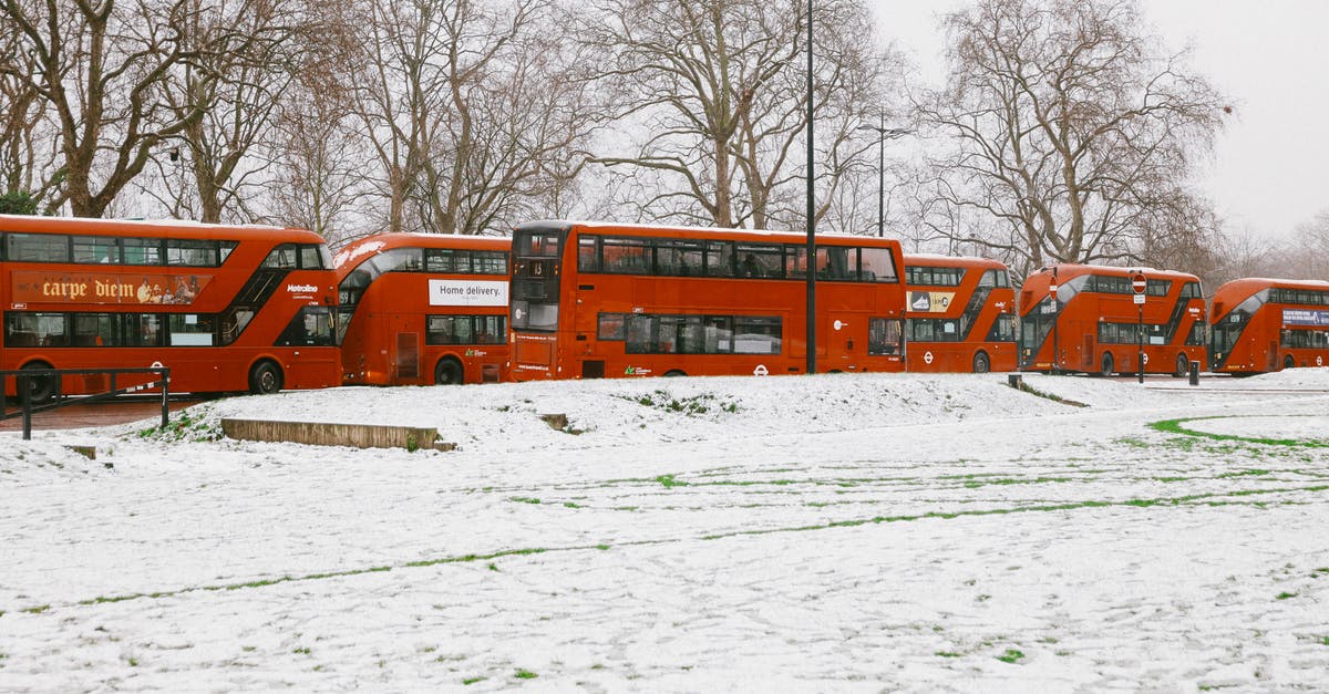 Where is Jasmeet born, in London or India? - Red Double Decker Buses Near Snow-Covered Ground