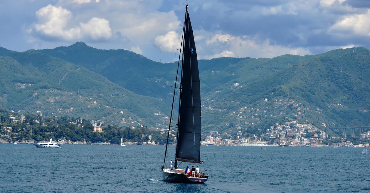 Where is Sator between the Vietnam Yacht and Italy? - Sailboat on Sea Near Green Mountains