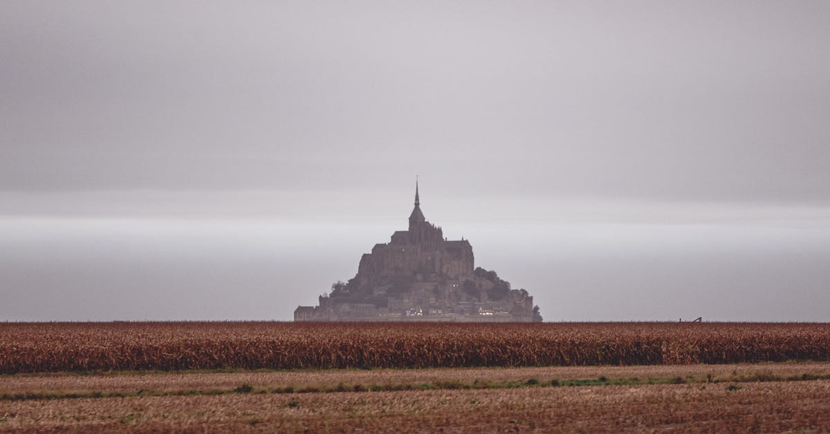 Where is this place from Silicon Valley 3? - Scenery of distant grand Mon Saint Michel Abbey situated on vast grassy valley under cloudy gloomy sky