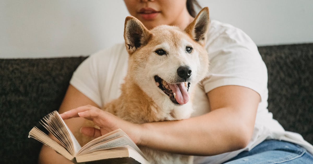 Which Live action The Jungle Book adaptation is more faithful to Kipling's novel? - Focused Asian woman with Shiba inu reading book