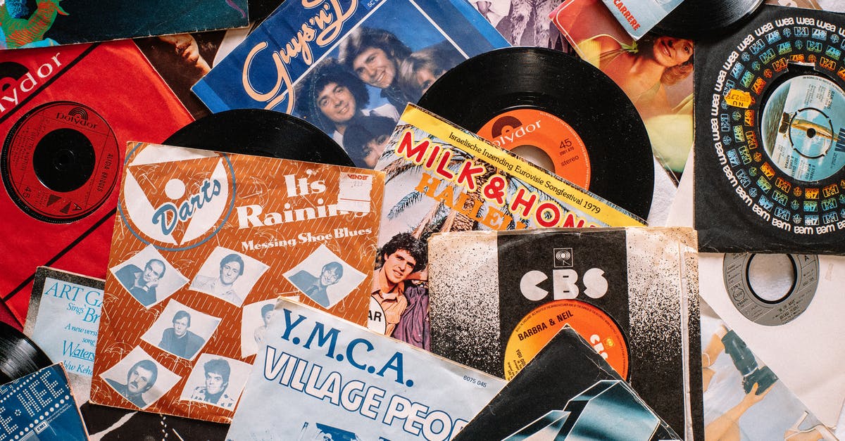 Which songs were performed more than once on Glee? - Set of retro vinyl records on table