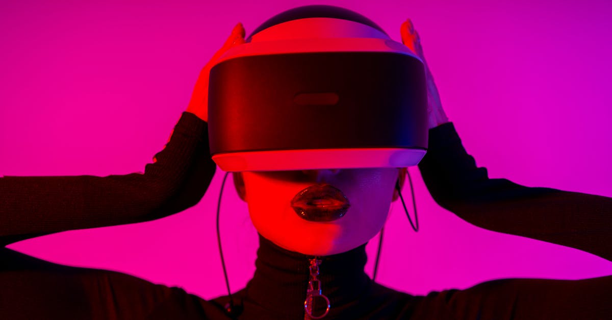 Which was the first reality competition TV program that used the now common format of eliminating one contestant each episode? - Astonished young female using virtual reality goggles while experiencing invisible reality on pink background