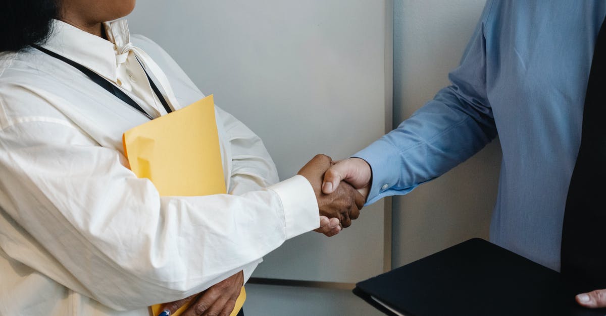 Who's the negotiator in The Negotiator? - Diverse coworkers shaking hands after meeting
