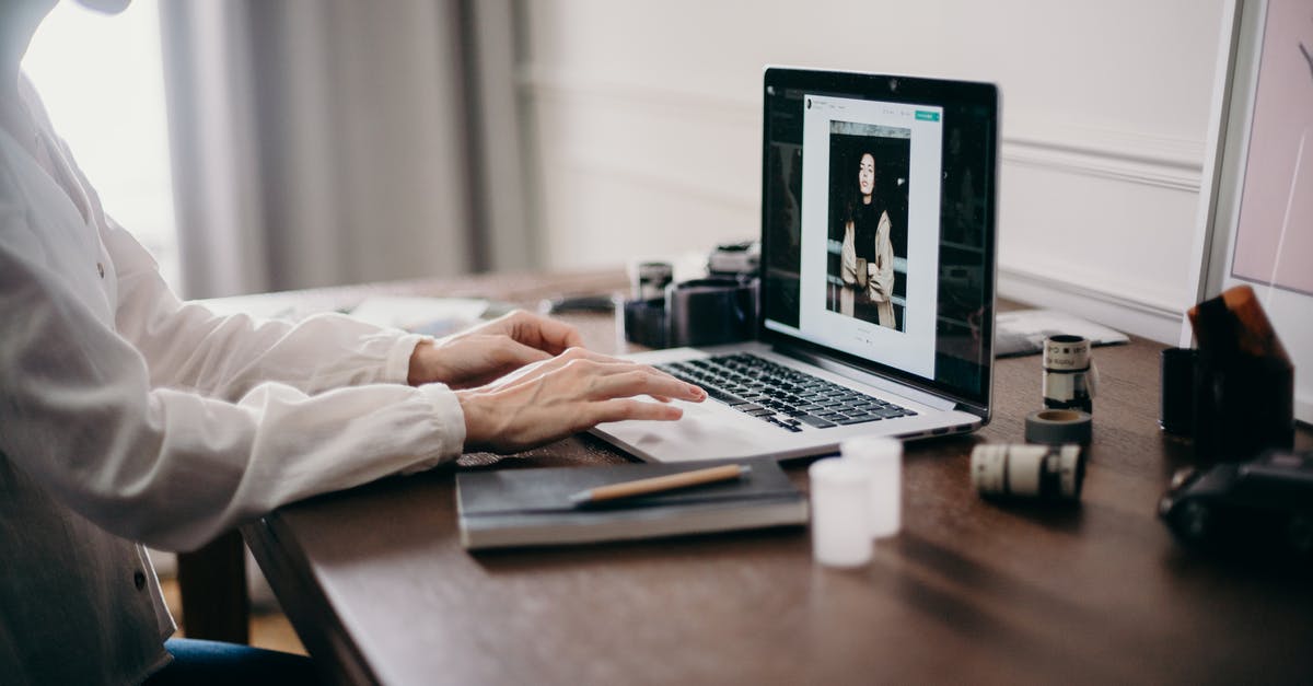Who are depicted in a photo in Sam's office? - Selective Focus Photography of Woman Using Macbook Pro