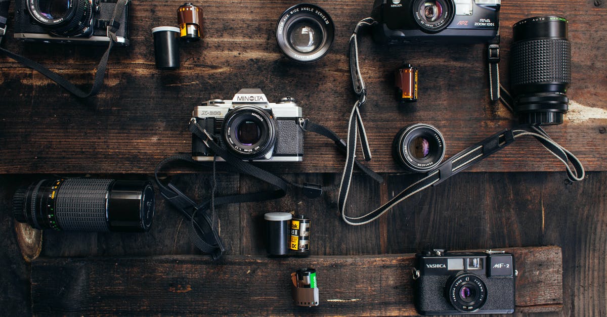 Who arranged the camera at the hospital? - Overhead of retro photo cameras near various lenses and films on wooden surface