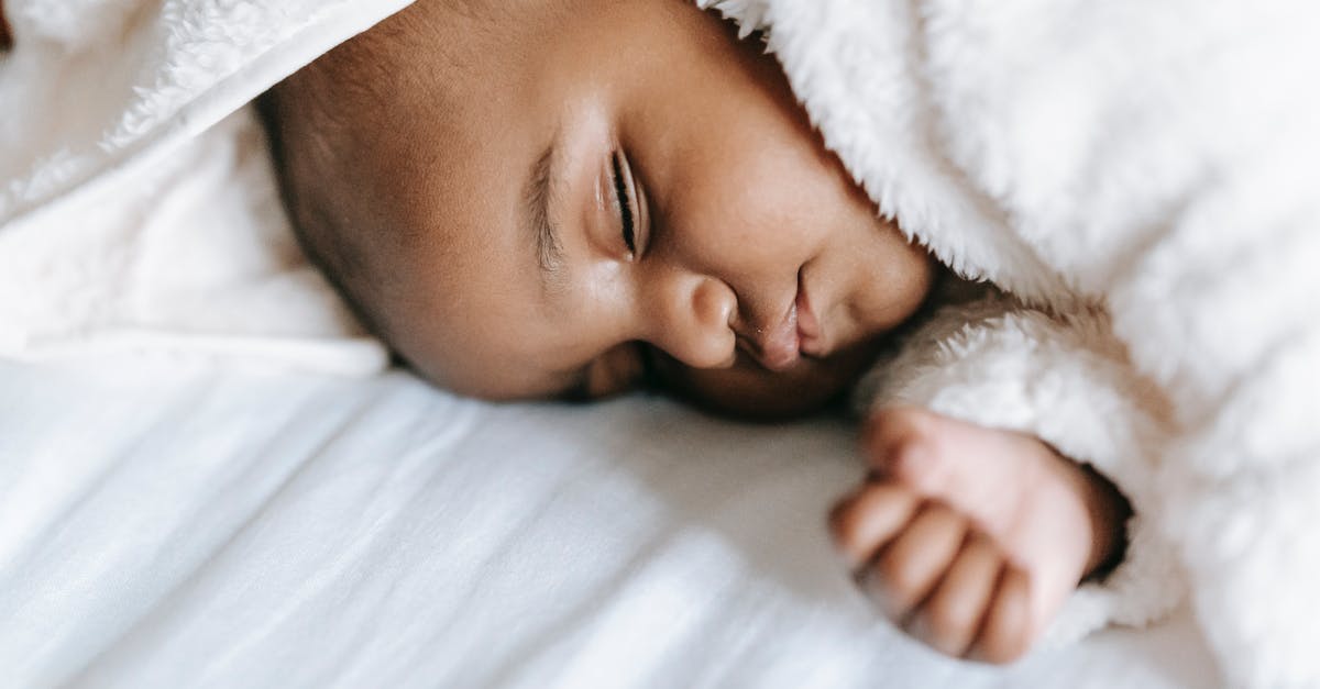 Who ended up on the hood of the Serenity? - Sleeping newborn black baby lying on bed