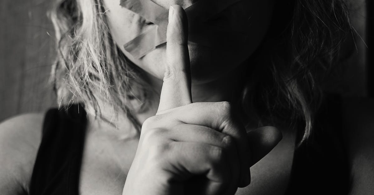 Who held the girl in the secret room? - Woman Placing Her Finger Between Her Lips
