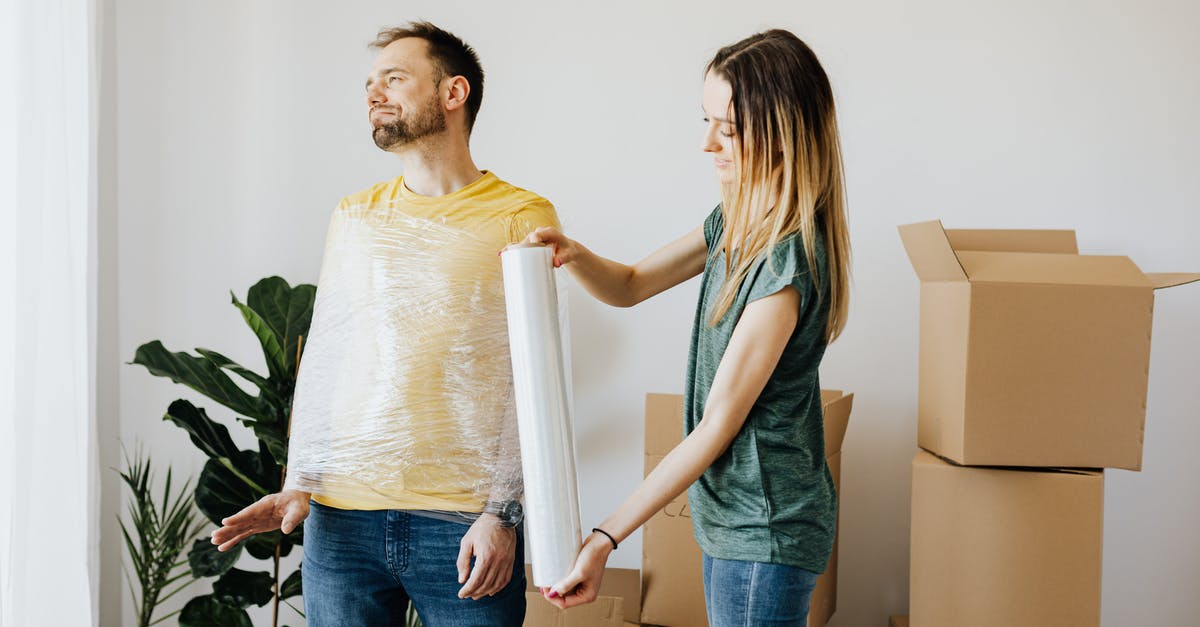 Who is Bruce and does he have a real-world counterpart? - Content couple having fun while girlfriend in casual wear wrapping boyfriend with clingy plastic roll during packing belongings into carton boxes before moving in together