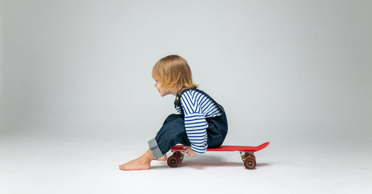 Who is the boy referred to in the title of the movie "The Boy in the Striped Pyjamas"? - Boy in Black and White Striped Long Sleeve Shirt Sitting on Red Skateboard