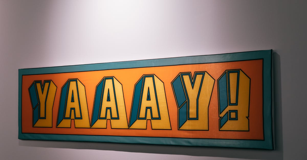 Who put the Ojibwe phrase on the board at Tony's hospital room? - Rectangular decorative orange sign with green framing and joyful Yaaay word hanging on white background with shadow in light room