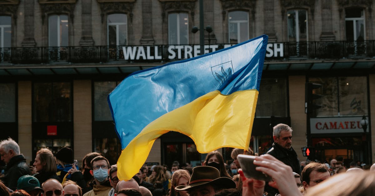 Who was the crowd around the villain at the end of “Star Wars: The Rise of Skywalker”? - Blue and yellow Ukrainian Flag Waving Above Crowd of People