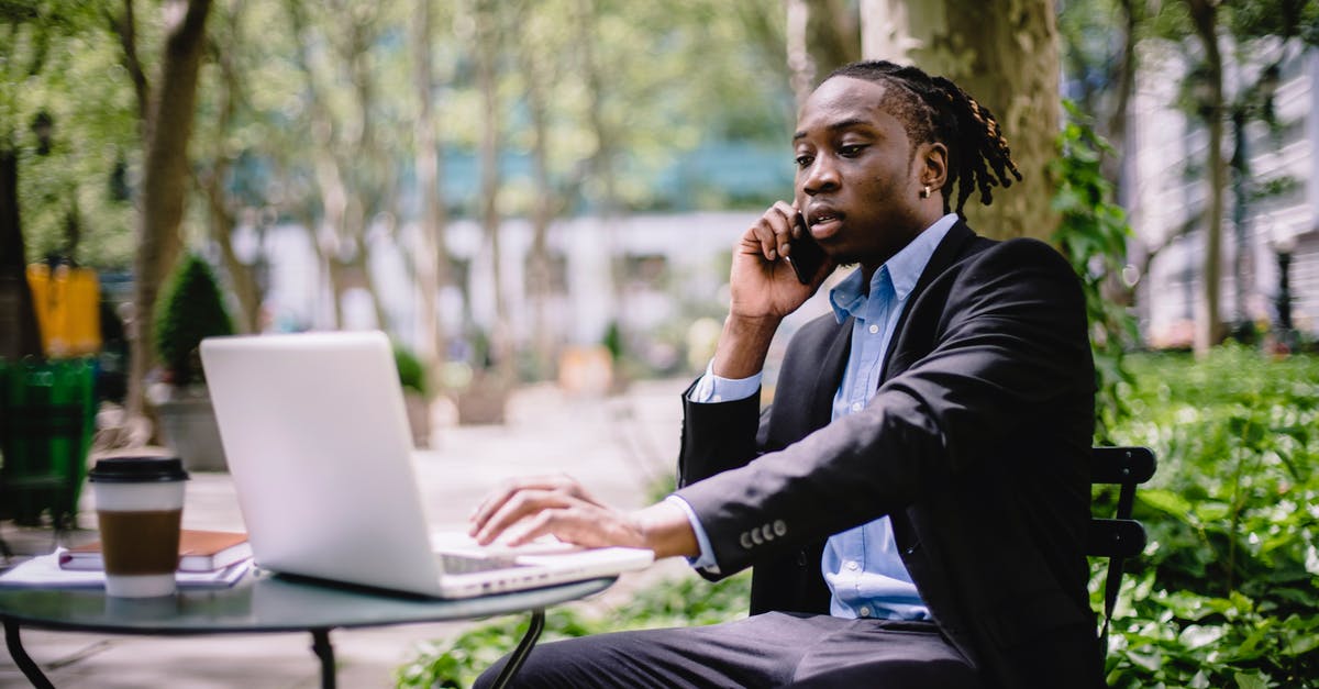 Who was the guy always talking to Cole and why did he use to call him "Bob"? - Serious stylish young African American male manager in formal wear browsing laptop while having phone call in outdoor cafe