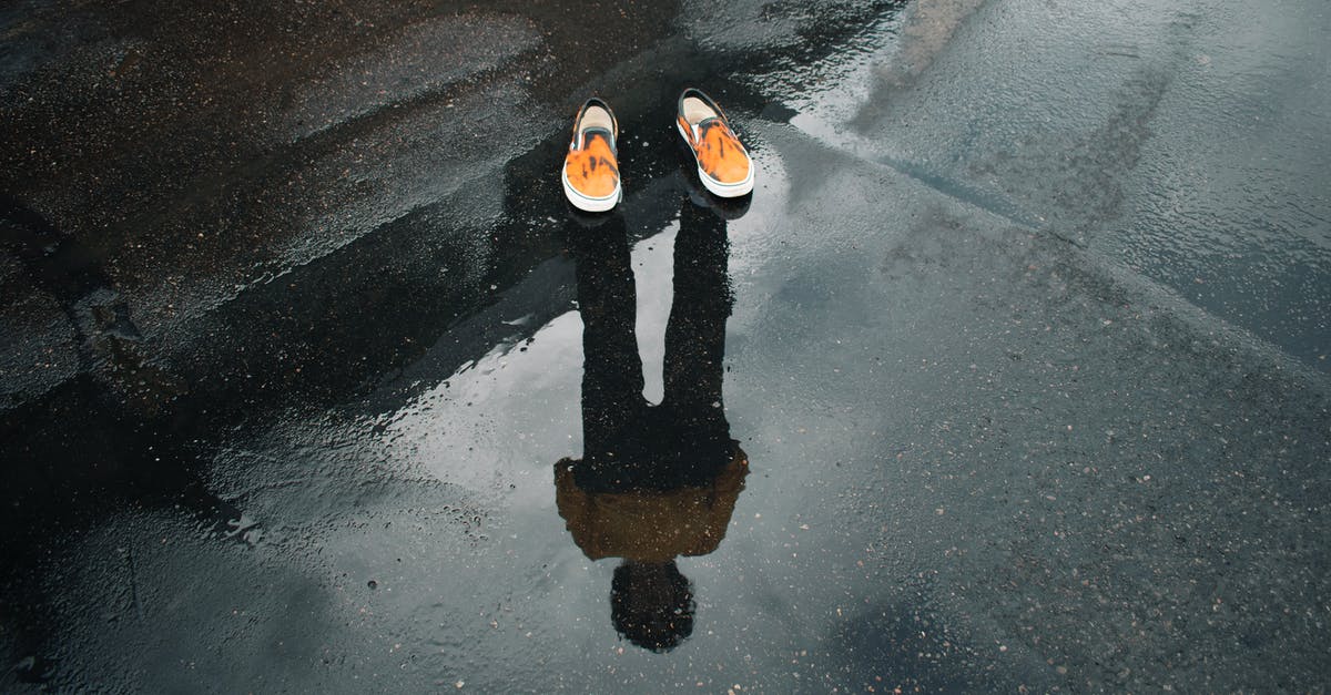 Whose body is in the rain puddle in The Matrix Revolutions? - Orange-and-white Shoes