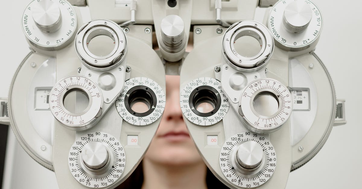 Whose grave did the doctor and the sheriff visit? - Woman diagnosing vision on refractor testing device during eye examination in modern ophthalmology clinic