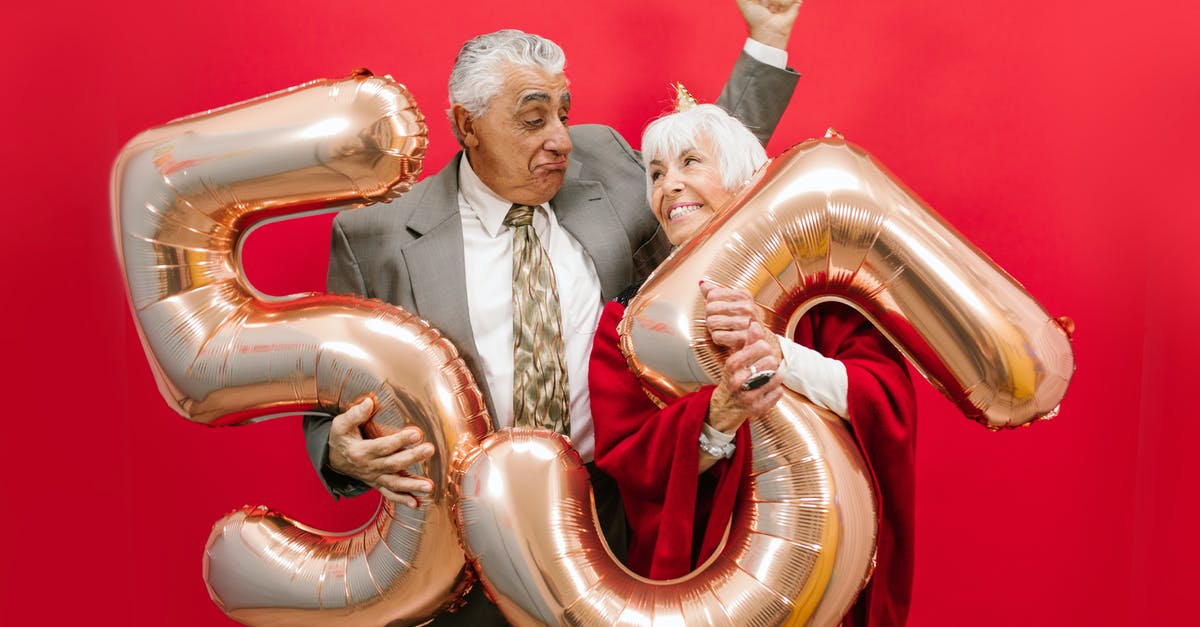 Why 28 and not any other number? - A Couple Holding Number Balloons With Red Background