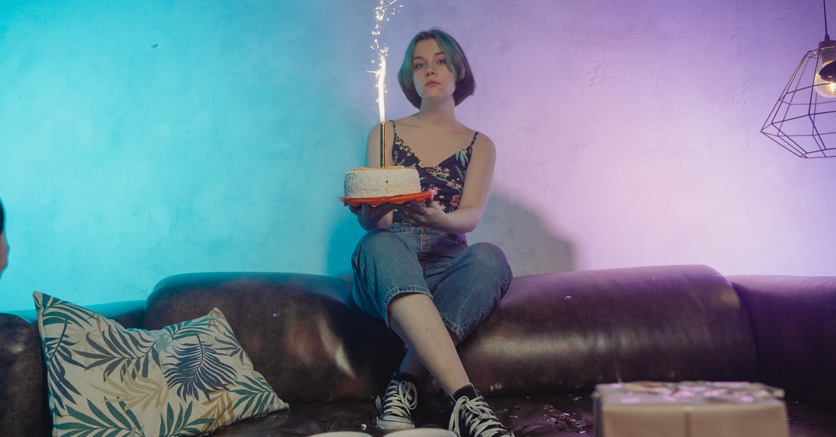 Why are all of Mr. Shirley's gifts the same? - A Woman Holding a Birthday Cake with Firecracker