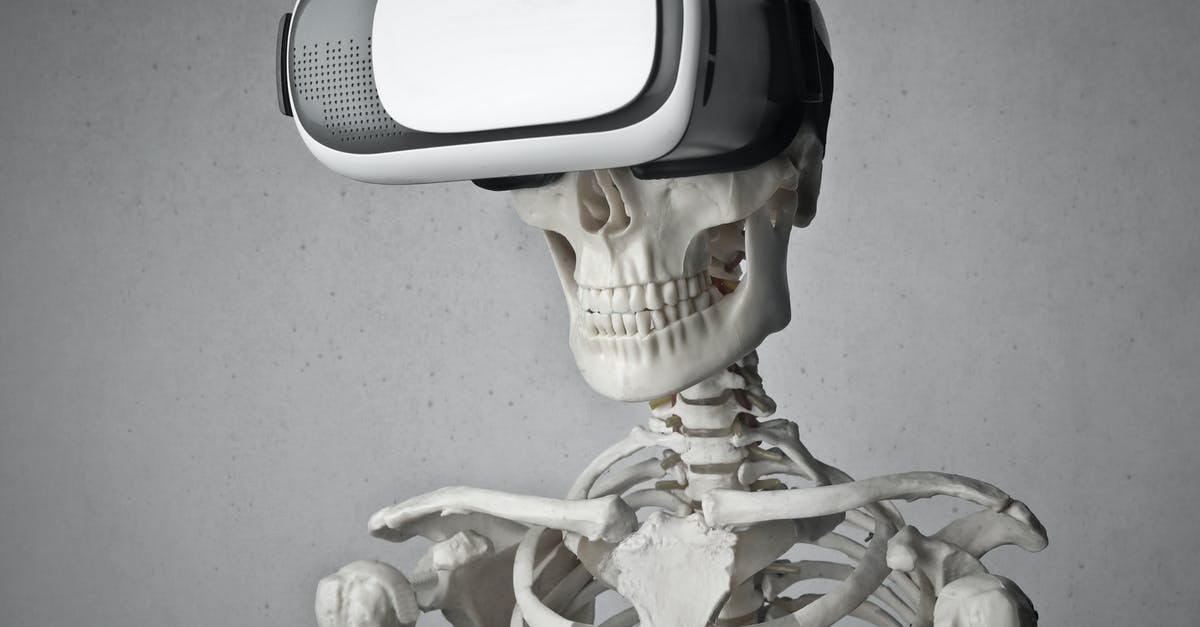 Why are Pluto and Goofy so different? - Portrait Photo of Skeleton In Front of Gray Background With White and Black VR Goggles on