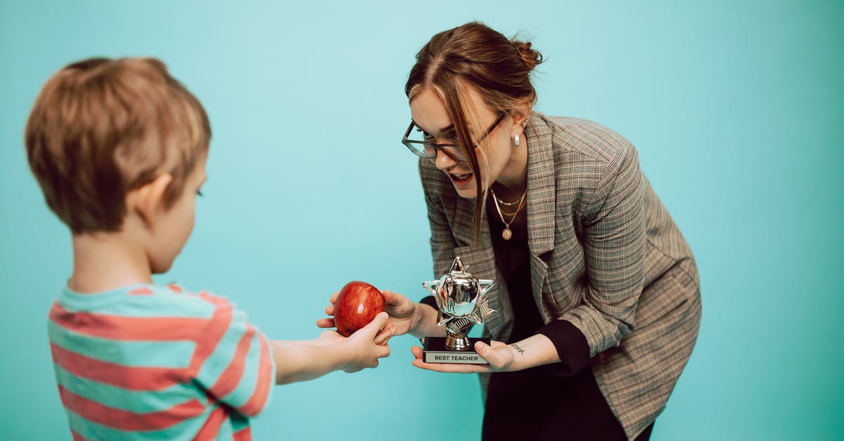 Why are some of Kids' awards rewarded to non-kids' movies? - A Woman Giving an Apple and a Trophy to a Boy