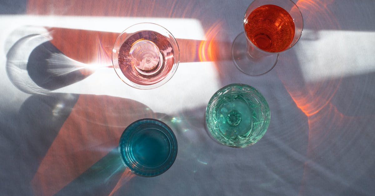 Why are sound effects done so different from reality? - Top view of transparent glasses filled with different beverages and placed at sun beam