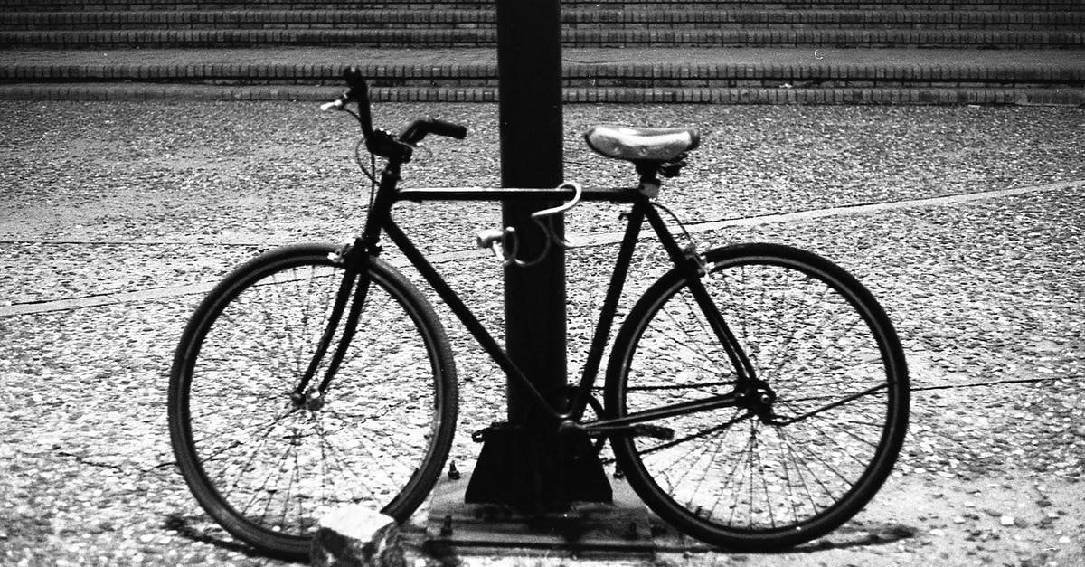 Why are the crew members in Passengers locked in? - Grayscale Photo of Bicycle Leaning on Metal Fence
