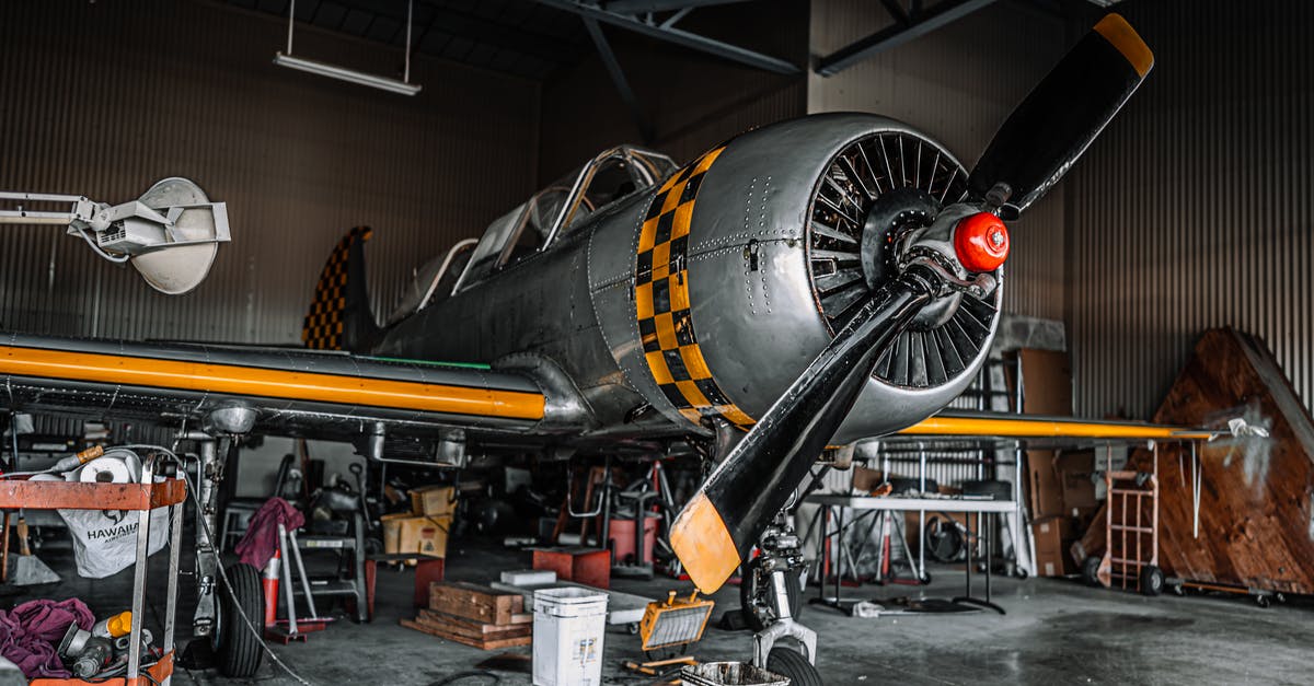 Why are the Terminators dragging a turbofan jet engine? - Old fashioned gray propeller jet parked for maintenance in modern spacious air shed