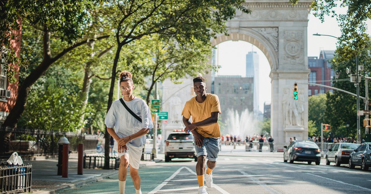 Why aren't Annie and Jack together in Speed 2? - Full body of serious multiethnic male skateboarders riding skateboards along road against Triumphal Arch in New York