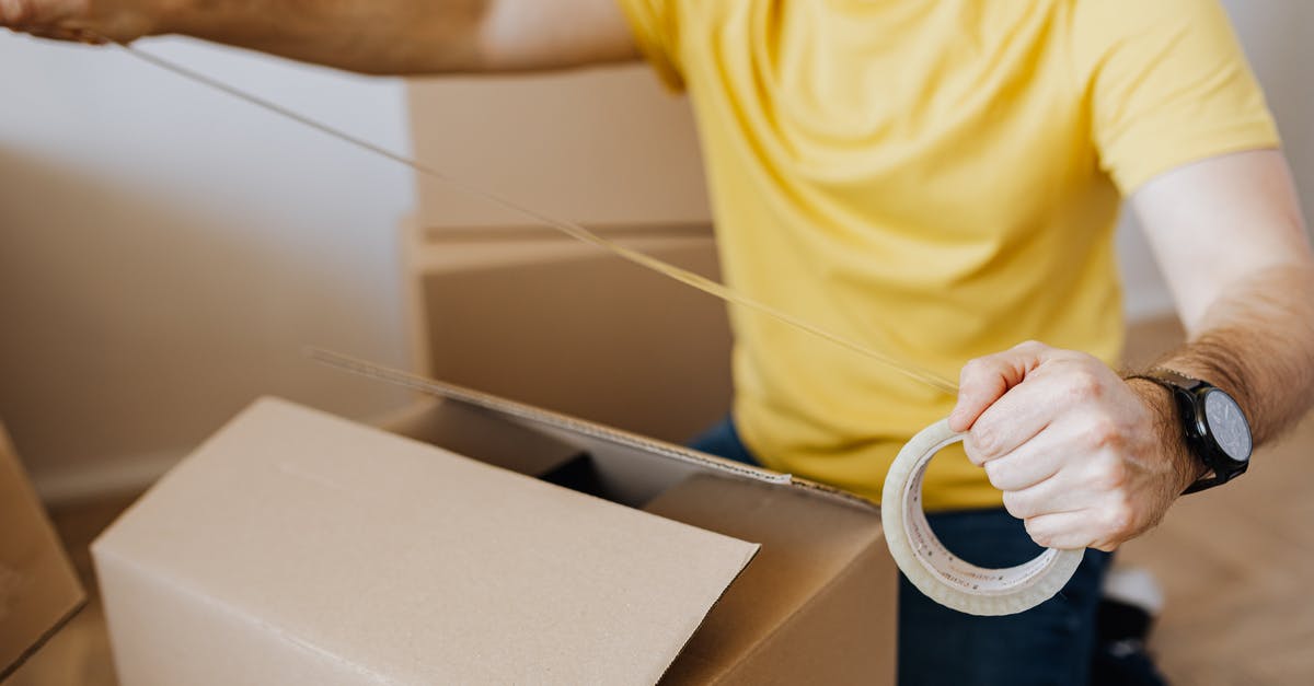 Why aren't Kaylie and Tim packing the things and leaving the house since the experiment is impossible to complete? - Crop man with cardboard boxes while packing belongings