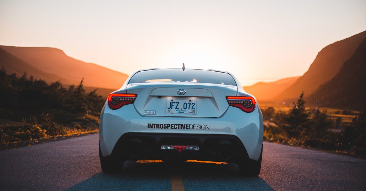 Why can't Parzival drive the car in forward in the first level? - Back part of modern white automobile on paved highway road in mountains glowing with sunset light