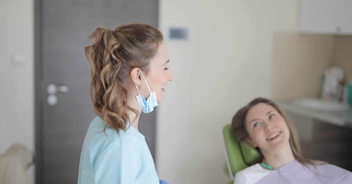Why can't they visit each other? - Cheerful young female dentist talking with patient in modern clinic