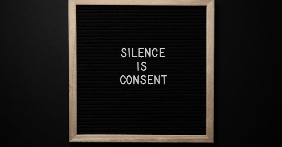 Why change translation text into a picture for international versions? - From above blackboard with written phrase SILENCE IS CONSENT on center on black background
