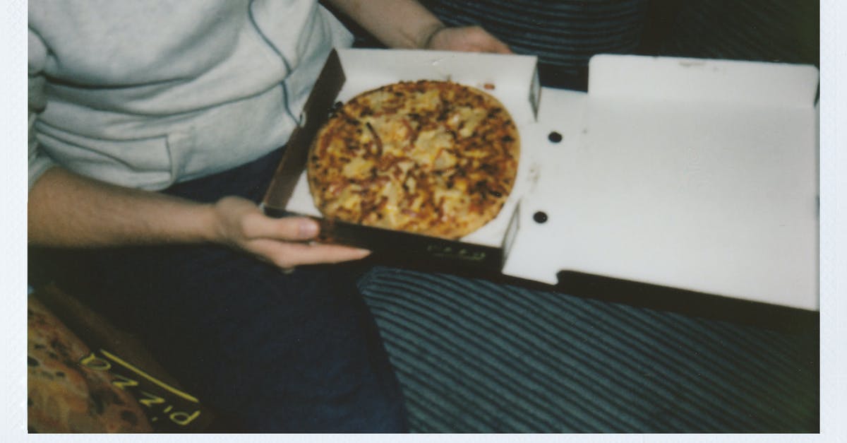 Why Cheese Box may contain nuts? - Person Sitting Holding a Box of Pizza