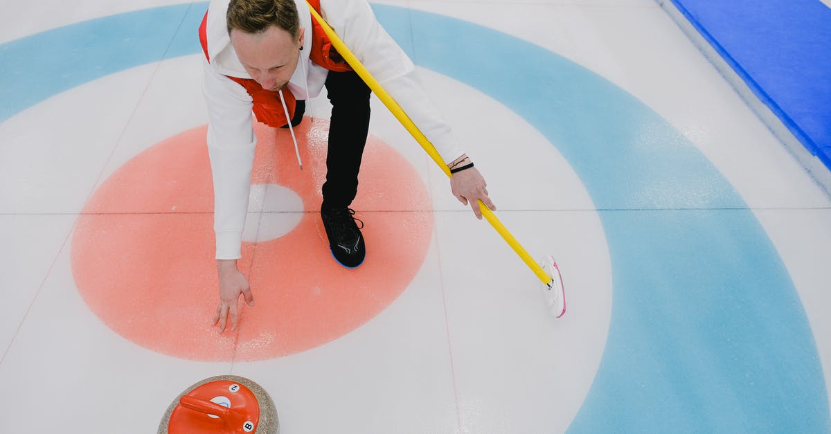 Why did Bauria throw the drugs into the well? - From above of concentrated sportsman in activewear throwing stone during curling competition on ice rink in daytime