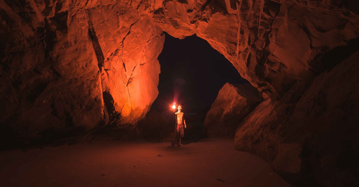Why did Blake fire his flare gun? - Person Standing and Holding Lamp Inside Cave