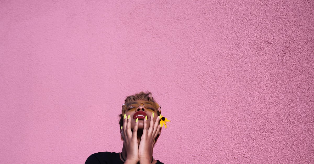 Why did Claire change her hair color to black and then later back to blonde? - Stylish young African American female in casual wear and sunglasses with closed eyes touching face while throwing head back on pink background
