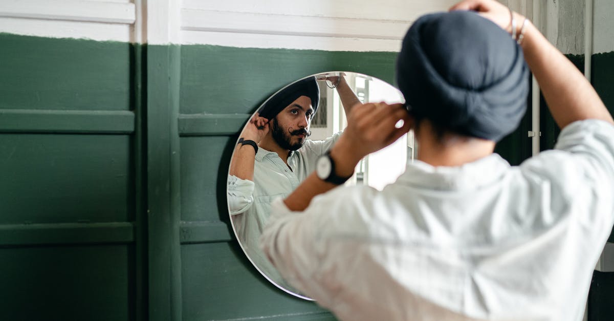 Why did French see himself as Homer in the mirror? - Young ethnic man looking of mirror at home