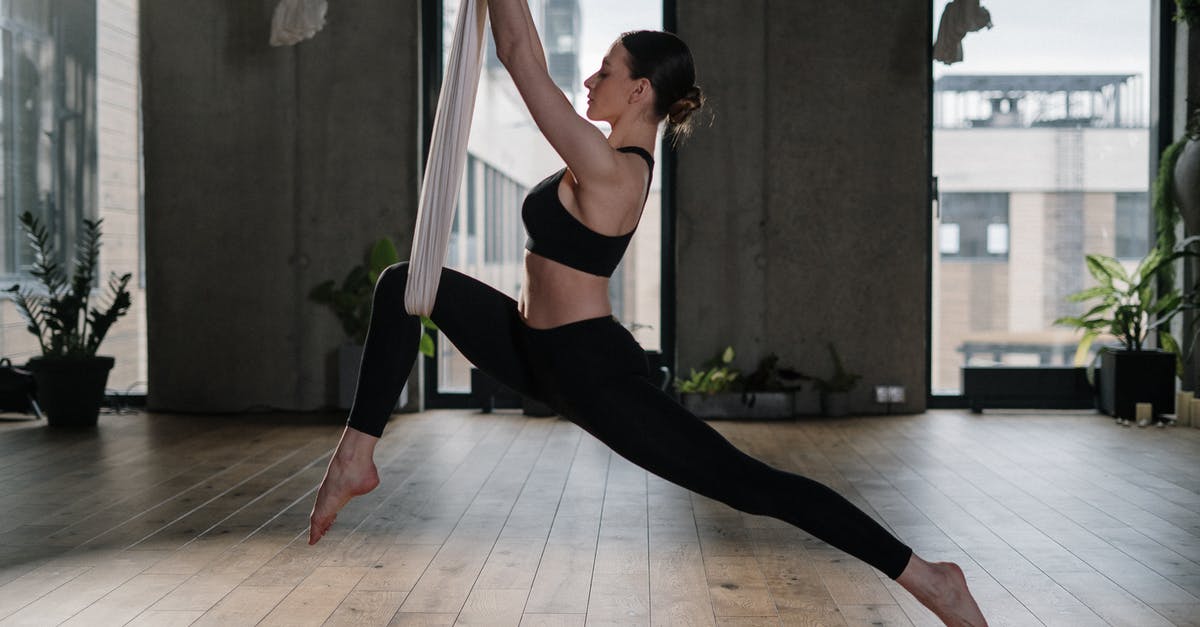 Why did gravity temporarily reverse when the mothership landed? - Woman in Black Sports Bra and Black Leggings Doing Yoga