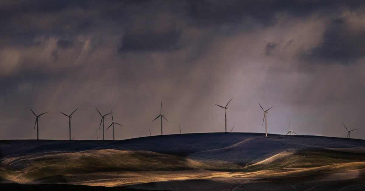 Why did it rain after they jumped on a cloud? - Wind Turbines on Brown Field Under Gray Clouds