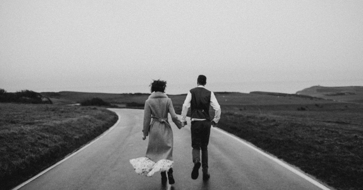 Why did Katniss and Gale not run away when they had the chance? - Grayscale Photo of Couple Walking on Road