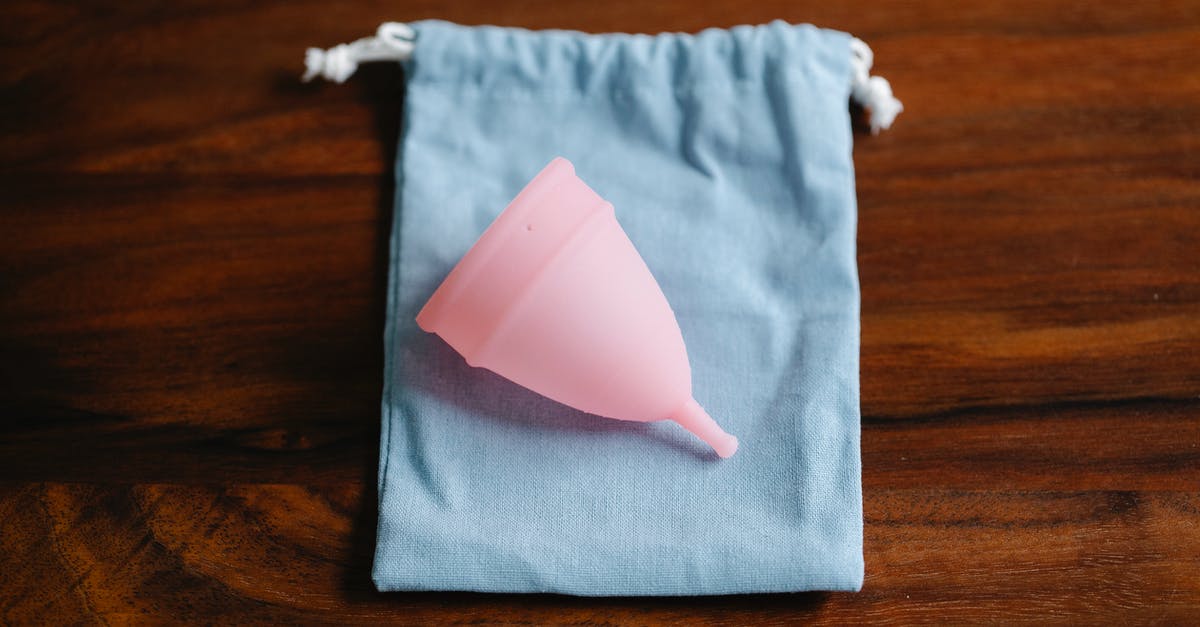 Why did Light have to kill 23 lesser criminals during the period Dec 19 to Dec 27? - Top view of pink menstrual cup for feminine hygienic procedure on cloth bag placed on wooden table in light room