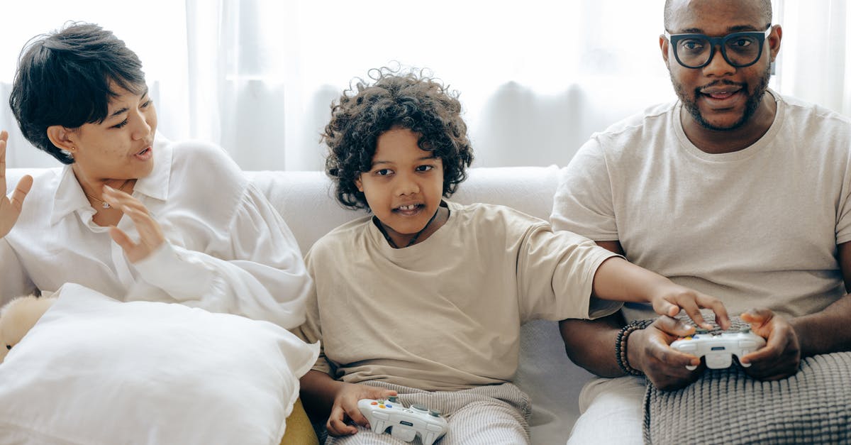 Why did Luke's mom stop tucking him in? - Interested ethnic kid preventing father from winning in video game while resting together with mother in living room