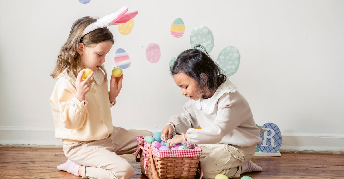 Why did Riggan Thomson choose to end his play that way? - Side view of adorable little Hispanic girl choosing colorful Easter eggs while playing with friend on floor at home