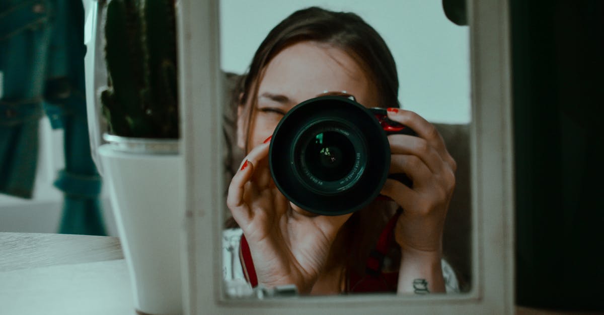 Why did S I Tilak shoot through a bottle? - Woman taking photo through small mirror