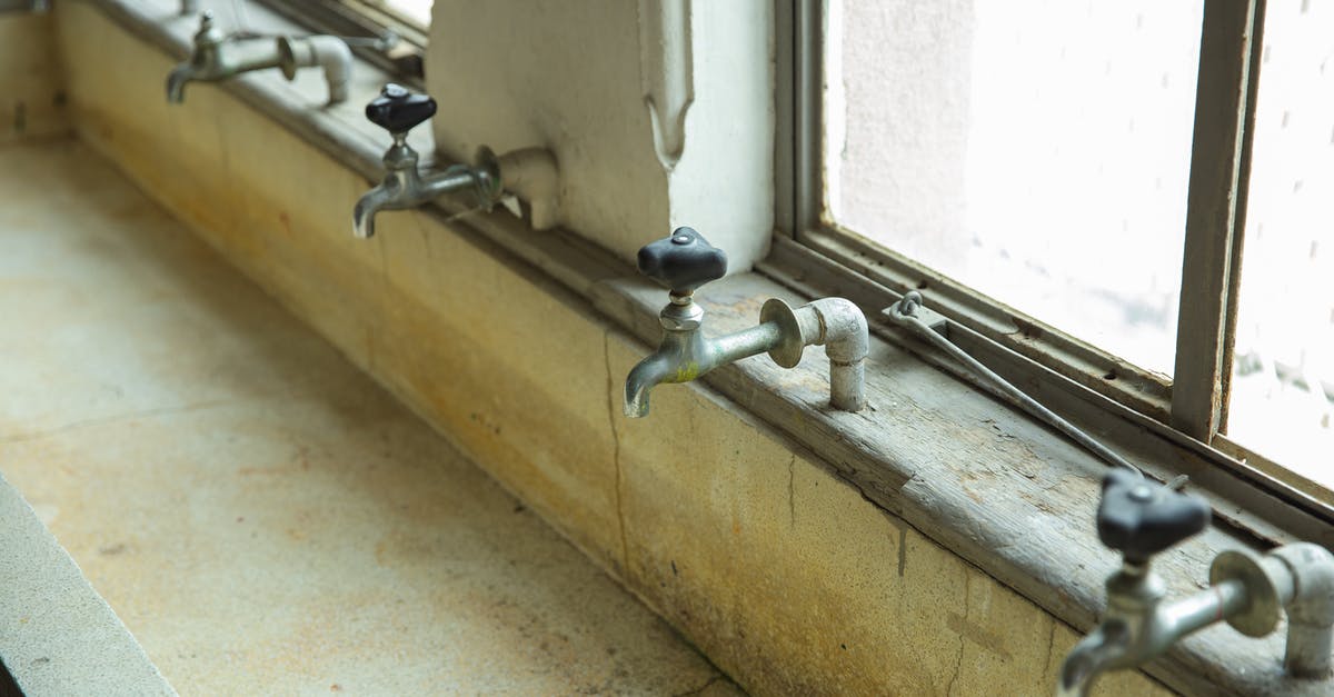 Why did she throw this tap valve? - Similar old taps above weathered public sink in building