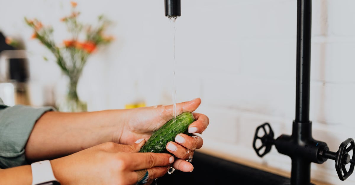 Why did she throw this tap valve? - Person Holding Green Vegetable With Water Droplets