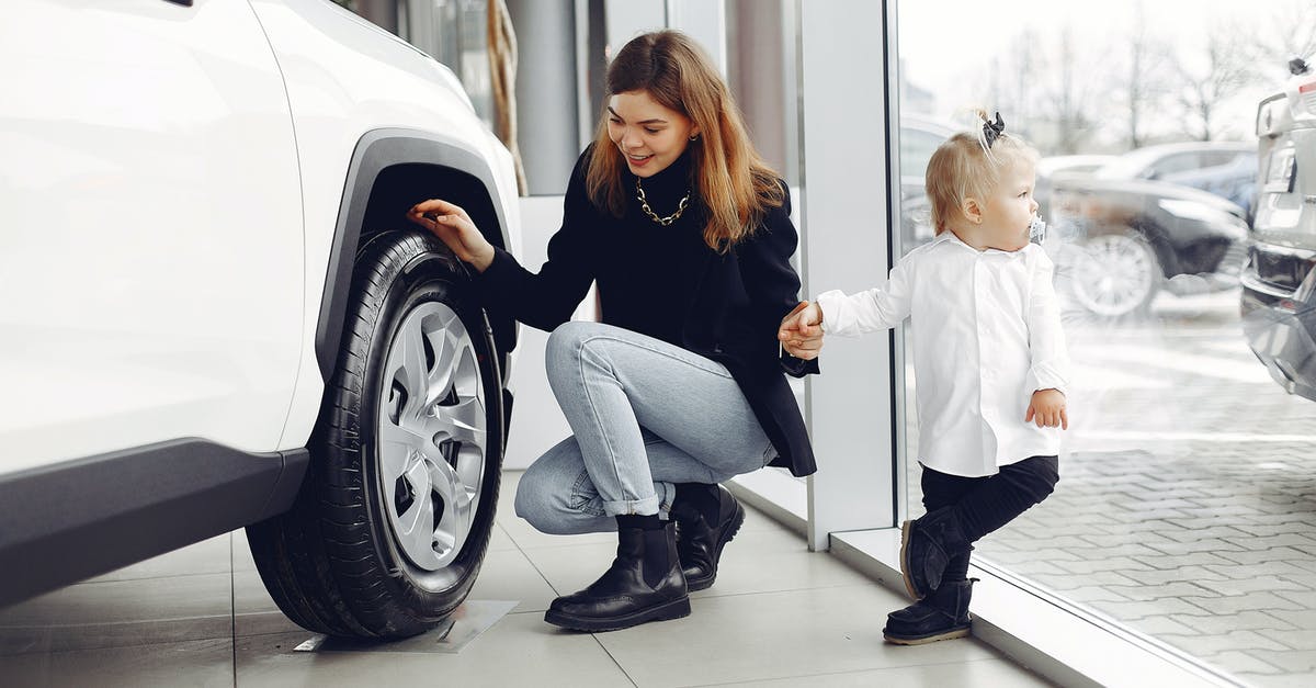 Why did the Child Protection Service still appoint Messer to parent Sophie even with rude behavior? - Full length of cheerful smiling mother in jeans holding hands with cute little girl and looking at car wheel in car showroom in daylight
