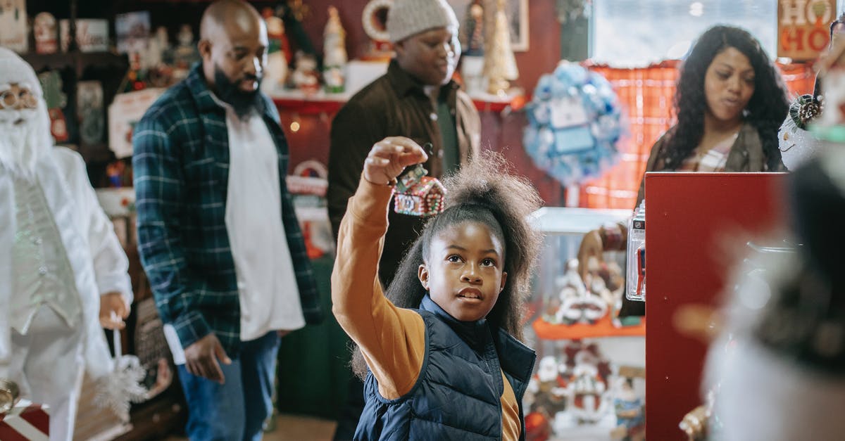 Why did the Observers choose the year 2015? - Young African American parents with son and daughter looking for New Year gifts in souvenir shop