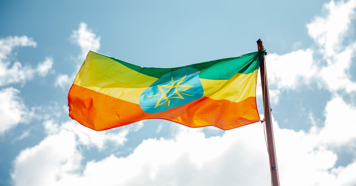 Why did the troglodytes come to Bright Hope? - National colorful flag of Ethiopia under cloudy sky
