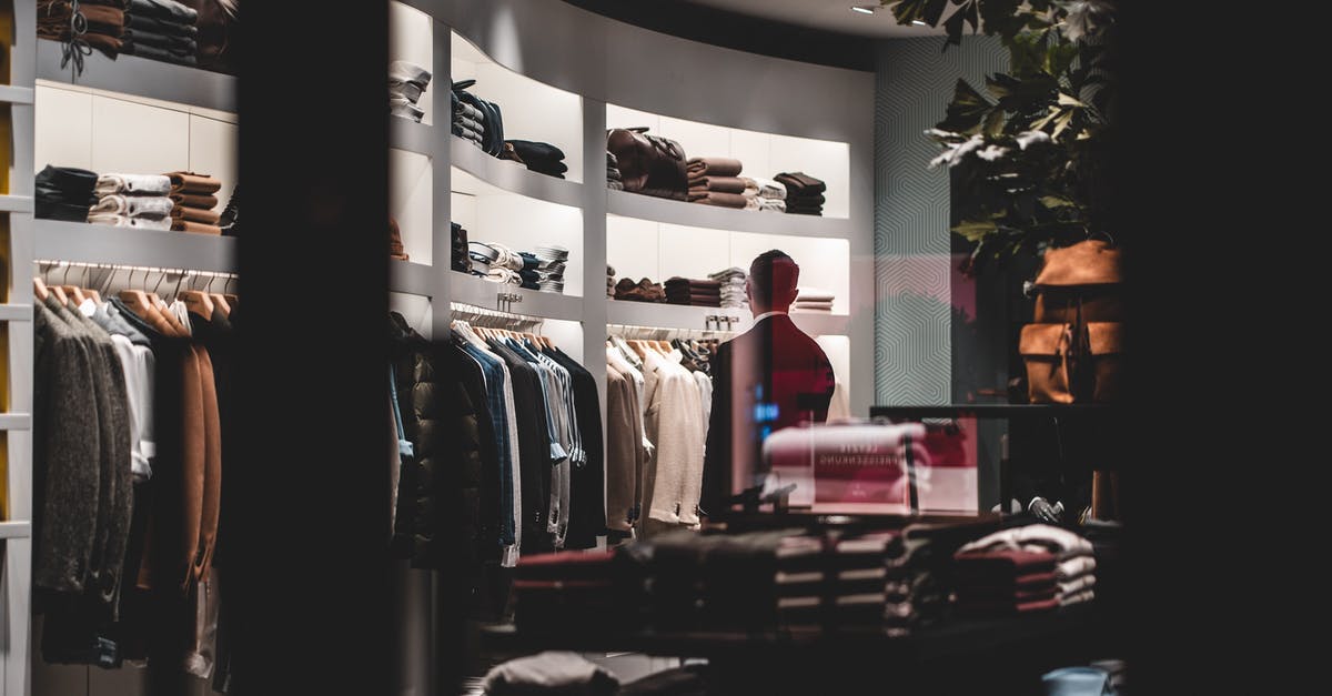 Why did the writers choose this development for Moriarty? - Back view of faceless elegant male customer in suit choosing new clothes while standing near wardrobe in modern fashion boutique